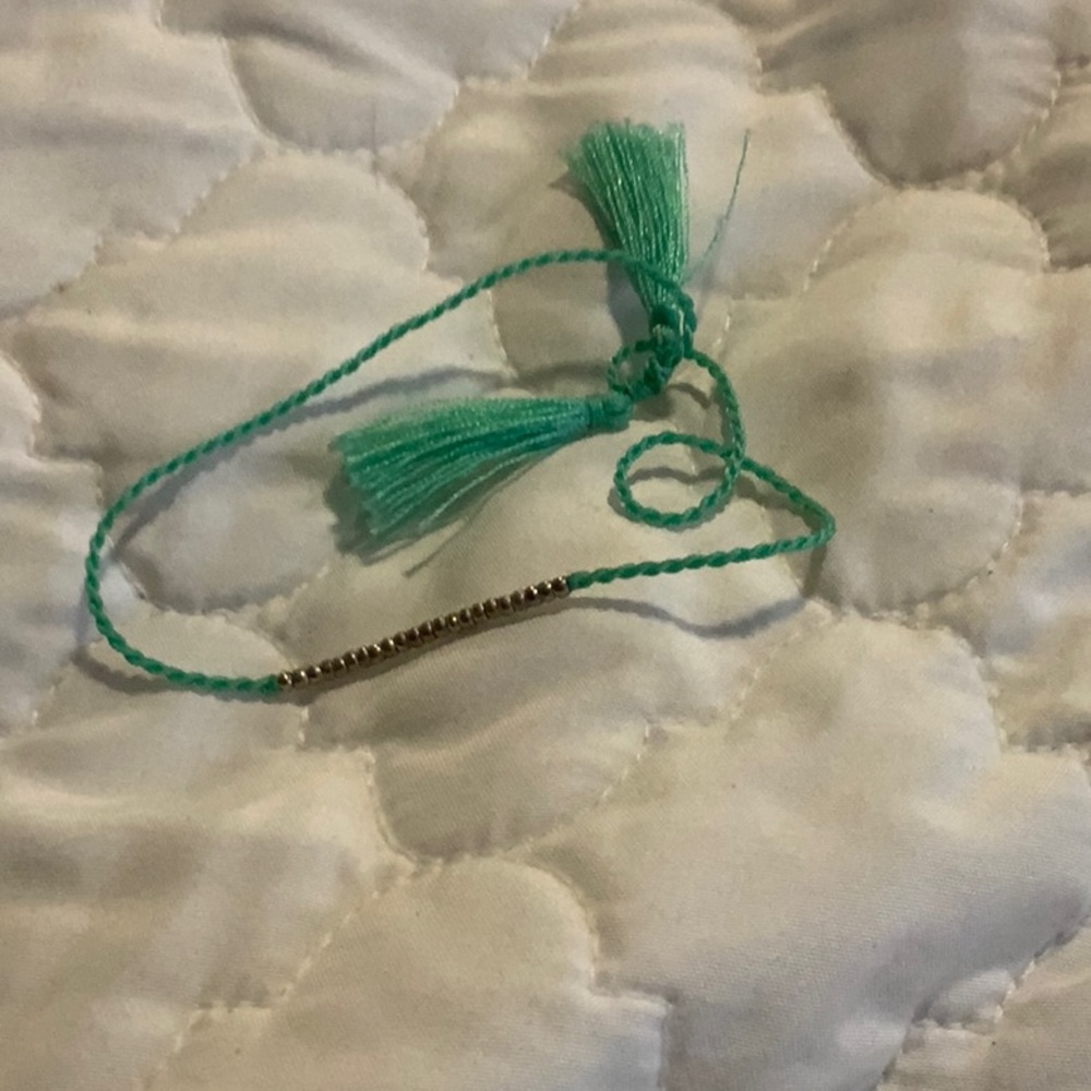 I am selling a teal and gold bracelet.
